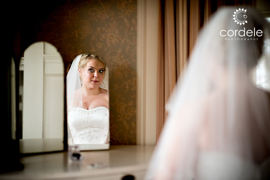 A bride sits at a vanity at the endicott estate wedding venue in Dedham Ma