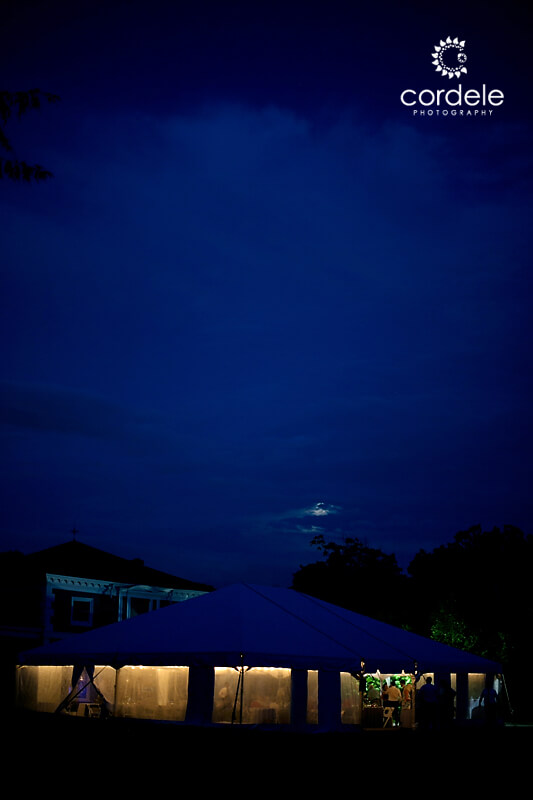 A night time photo of a tented wedding at Codman Estate in Lincoln Ma