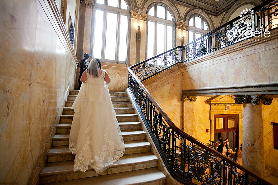 Bride walking upstairs of providence public library