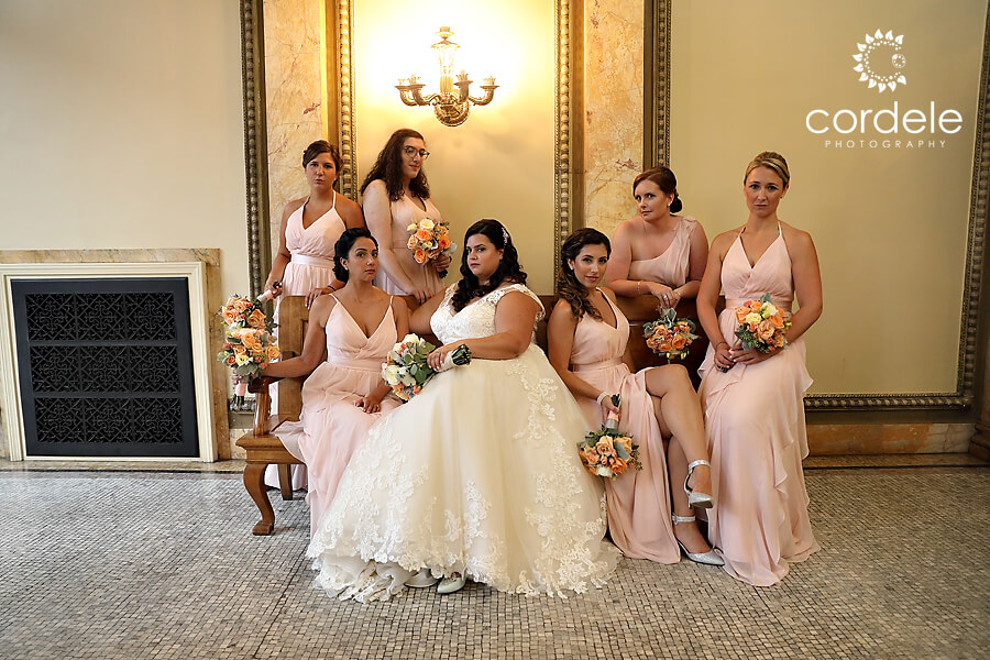 Bridal party sitting on bench inside providence public library