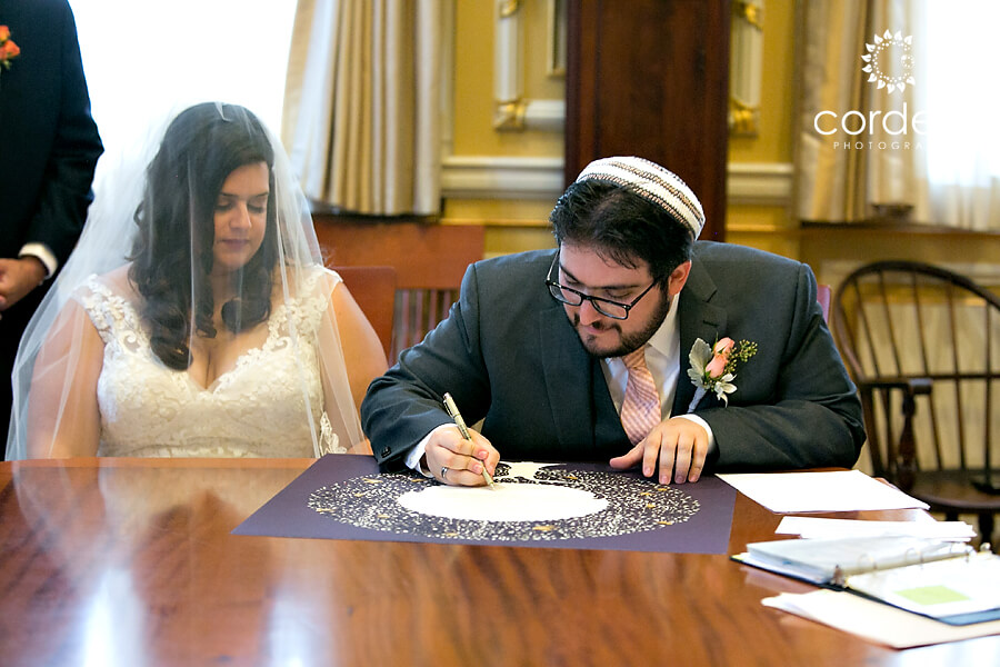 Groom signs Ketubah