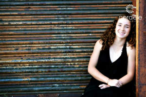 high school senior leaning against wall